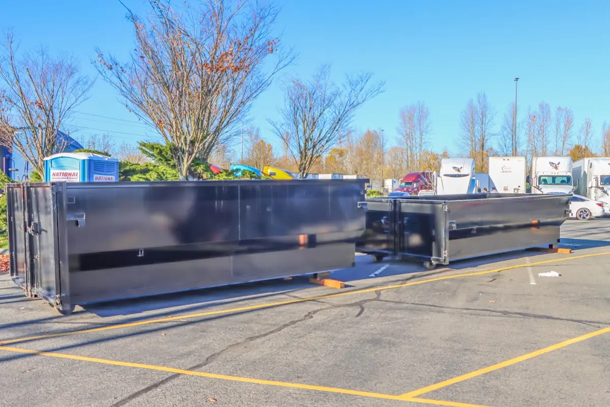 Professional dumpster rental service with roll-off container on residential driveway in Belvedere
